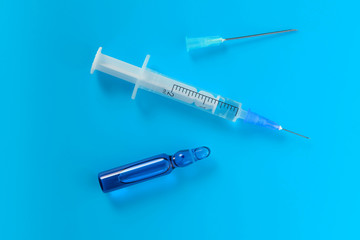 Medical vial with a syringe and needle
