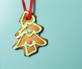 Image of gingerbread Christmas tree cookie over blue background