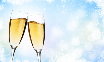 Two champagne glasses over christmas background
