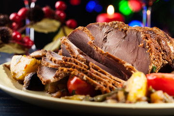 Fototapeta na wymiar Juicy roast pork on the holiday table