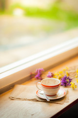 Coffee cup on wood bar in cafe