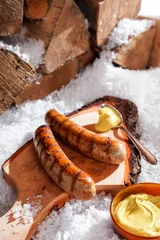 Tuinposter Grilled sausages served outdoors in the snow © exclusive-design