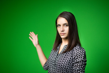 TV weather news reporter at work.News anchor presenting the world weather report.Television presenter recording in a green screen studio.Young woman with copy space on green screen chroma key
