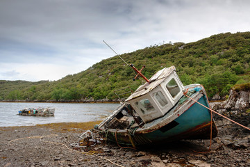 abandoned fishing boat lying on a rocky beach on the Isle of Lewis, Outer Hebrides, Scotland, UK, Europe  - 94866744
