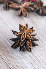 Star anise stacked over wooden background