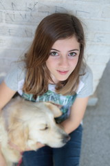 Teenage girl with her dog golden retriever