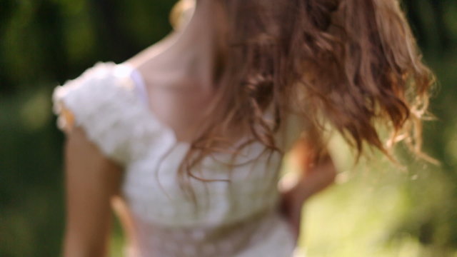 girl in white dress dancing in the forest and playing hair