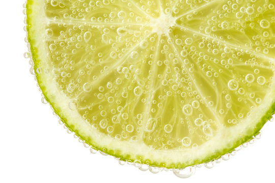 Green lime with water splash. Isolated on white background