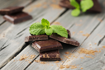 Dark chocolate with mint on the vintage table