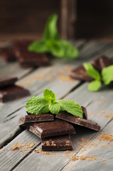 Dark chocolate with mint on the vintage table