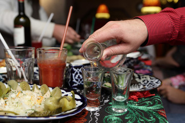 Person pouring vodka