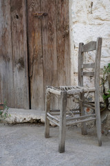 wooden chair in front of a building