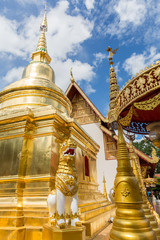 Naklejka premium Golden pagoda and singha at Wat Phra singha