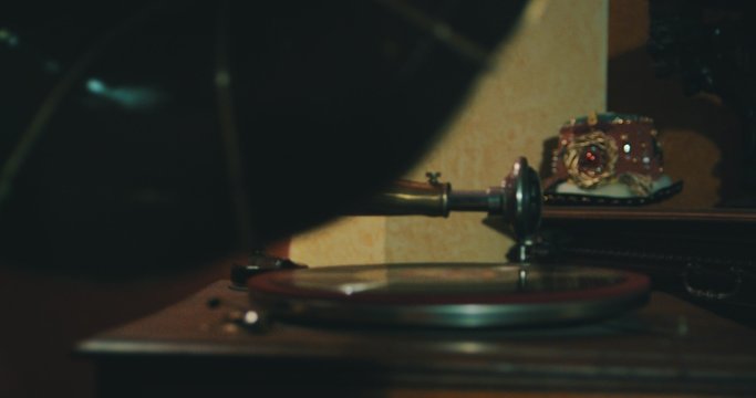 Old gramophone playing vinyl disc closeup.
