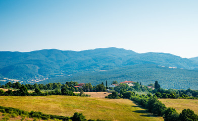 Obraz premium Tuscany, farmhouse in the countryside landscape, surrounded by golden hills, Italy.
