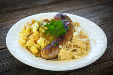 Roasted sausages with sauerkraut and potatoes