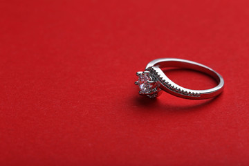 Diamond ring on a red background, close up