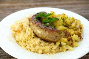 Roasted sausages with sauerkraut and potatoes