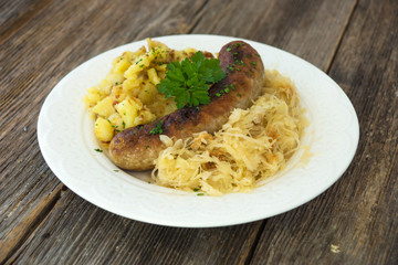 Roasted sausages with sauerkraut and potatoes