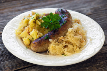 Roasted sausages with sauerkraut and potatoes