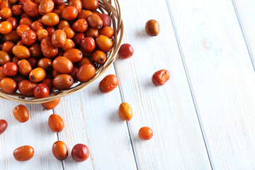 Ripe jujubes on blue wooden table, close up