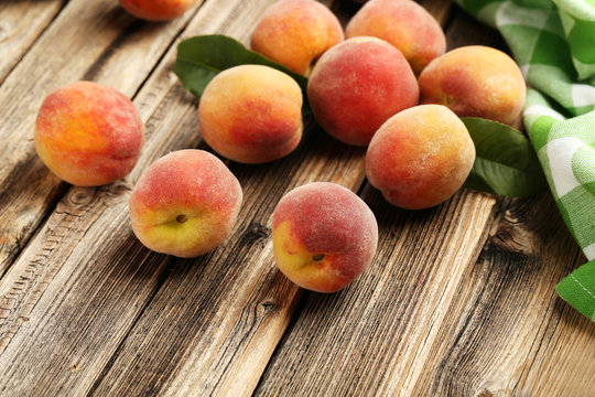 Ripe peaches fruit on a brown wooden background