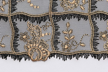 The macro shot of the gold and black lace texture materia