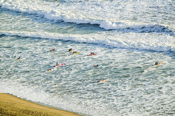 White surf and beach where surfer school sets out for surfing in Durban, South Africa on the Indian Ocean