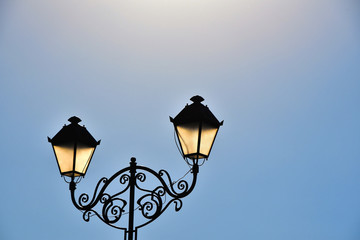 Fototapeta na wymiar Street antique double lamp post and blue sky