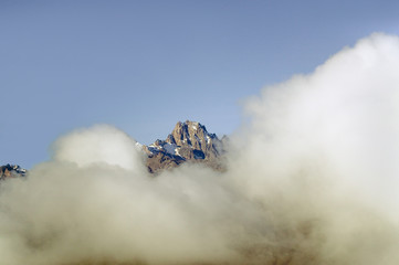 Aerial of Mount Kenya, Africa with snow and white puffy clouds in January, the second highest mountain at 17,058 feet or 5199 Meters