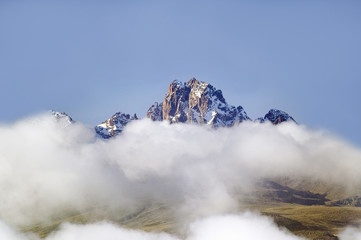 Aerial of Mount Kenya, Africa with snow and white puffy clouds in January, the second highest mountain at 17,058 feet or 5199 Meters