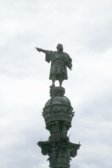 Fototapeta na wymiar Statue of Christopher Columbus points west over Atlantic Ocean to New World, waterfront of Port Vell, Barcelona, Spain
