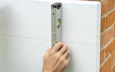 Check flatness of the wall using a level