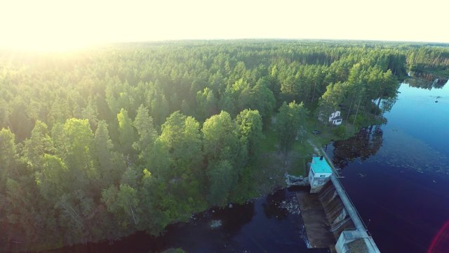 Aerial view of dam. Forest and lake. Aerial footage.