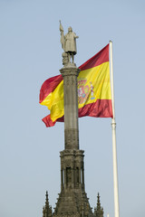 Spanish flag waves behind statue of Christopher Columbus, Plaza de Col—n in Madrid, Spain