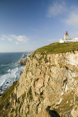 Fototapeta na wymiar Cliffs and lighthouse of Cabo da Roca on the Atlantic Ocean in Sintra, Portugal, the westernmost point on the continent of Europe, which the poet Cam›es defined as 