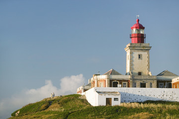 Fototapeta na wymiar The lighthouse on Cabo da Roca on the Atlantic Ocean in Sintra, Portugal, the westernmost point on the continent of Europe, which the poet Cam›es defined as 