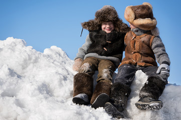 Children playing on a pile of snow
