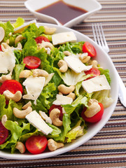 Green salad with brie, cashew and cherry tomatos