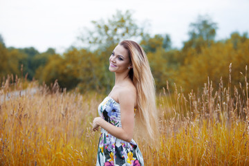   Beauty  women  in a straw hat alone with nature, profile