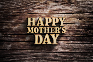 Fototapeta premium Happy Mother's Day. Words on old wooden board.