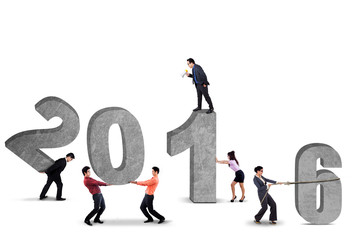 Group of businesspeople arrange numbers 2016