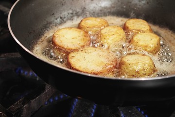 potatoes frying in pan