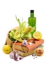 Vintage cookbooks with vegetable ingredients isolated on white.