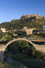 Fototapeta na wymiar Ancient stone arch bridges with a background of Parador de Cardona, a 9th Century medieval hillside Castle, near Barcelona, Catalonia, Cardona, Spain