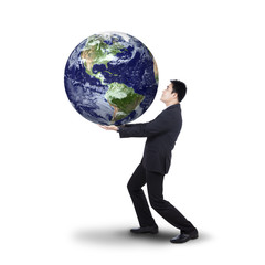 Successful businessman holding earth planet