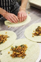 chef preparing indian chick pea wrap