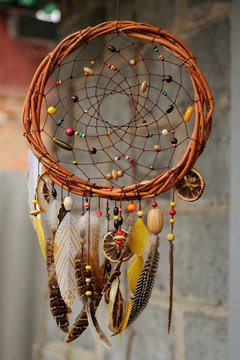 Handmade dream catcher at wall in background