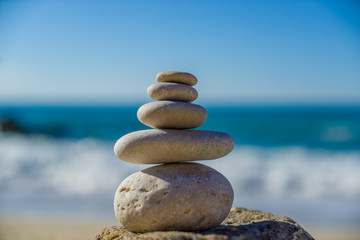 Stones balance, pebbles stack over blue sea in Croatia.