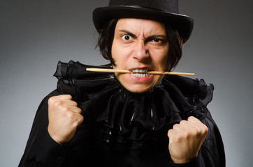 Funny magician wearing cylinder hat